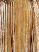 A gold Pullford maxi dress laid flat, emphasizing its flowing fabric and sophisticated style for evening wear.
