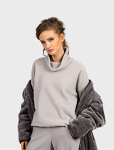 Soft, fluffy smoke-colored pullover sweater displayed on a hanger against a neutral background.