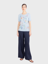Sky blue short-sleeve pullover with colorful floral embroidery, made from pure viscose for a soft, comfortable feel.