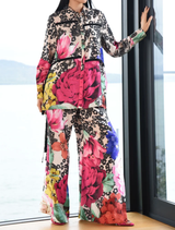 Vintage floral trousers with fluid wide legs, dramatic side splits, and an elasticated waistband for a blend of style and comfort.