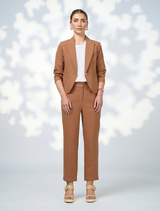 Quinn pants in a warm toffee shade, featuring a smooth fabric and a chic silhouette against a neutral backdrop.
