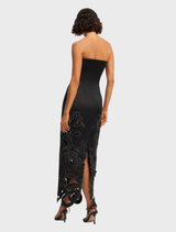 A long black maxi dress featuring an appliqué bustier design, elegantly draping to the floor.