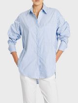 The image features a model dressed in a blue and white striped shirt, highlighting a trendy outfit choice.