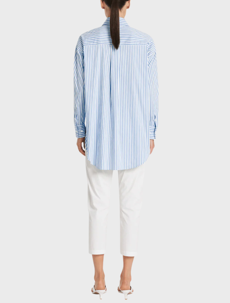 The image features a model dressed in a blue and white striped shirt, highlighting a trendy outfit choice.