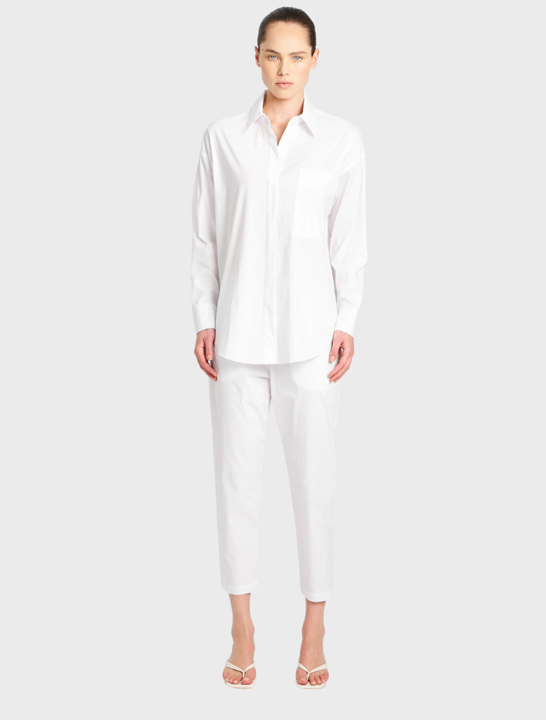 Front view of a white relaxed pocket shirt, highlighting its pocket detail and comfortable design.