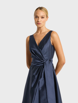 Navy Rene gown designed with a flattering silhouette and soft fabric, suitable for upscale gatherings.