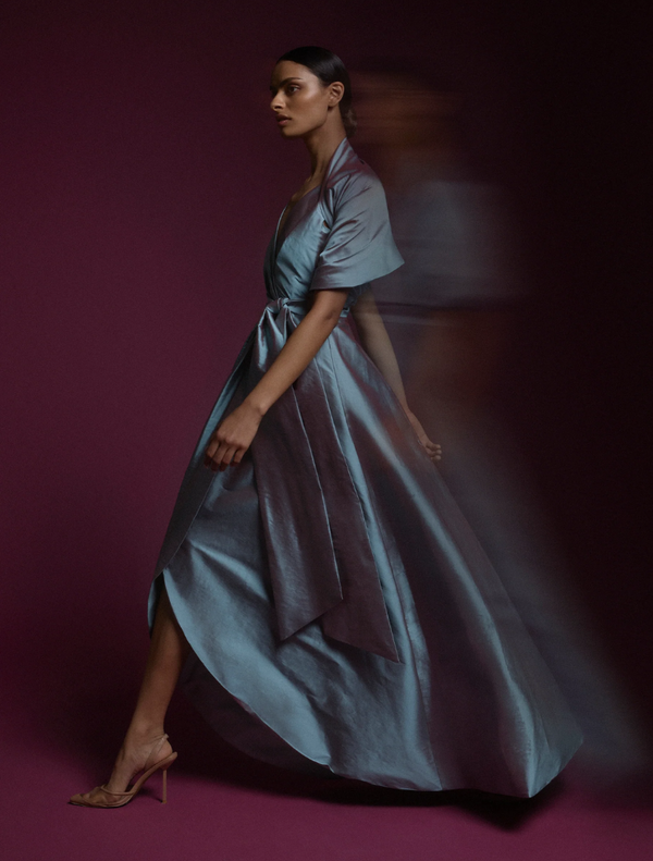 A dress featuring a bow on both the front and back, showcasing a stylish and playful design.