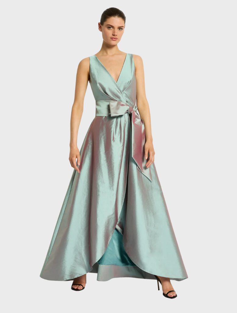 A dress with decorative bows on the front and back, highlighting its elegant and whimsical design.