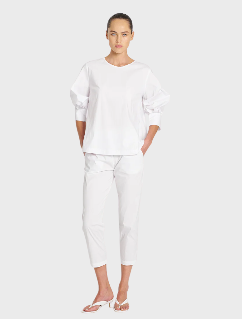 White cotton top with stylish puff sleeves, ideal for casual or dressy occasions.