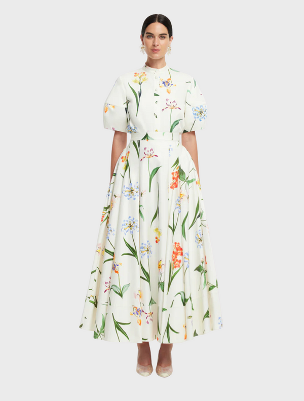 White floral print dress made from a soft cotton blend, showcasing a delicate and elegant design.