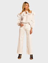 Close-up of a white Riva ruffled shirt, highlighting the intricate ruffles and smooth fabric.