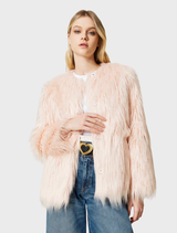 A pink coat displayed on a hanger, showcasing its elegant design and soft fabric texture.
