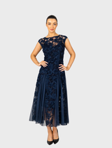 Navy Rosette Cap Sleeve Godet Gown featuring elegant floral details and a flowing silhouette.