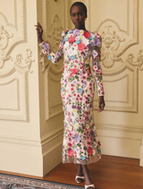 A multi floral long sleeve midi dress featuring a rosette design, showcased elegantly on a hanger.