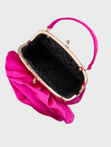 A fuchsia pink satin flower bag, known as the Rosita Rosette Frame Bag, hanging gracefully from a chain.