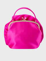 The Rosita Rosette Frame Bag, a pink satin flower design, elegantly draped from a chain.
