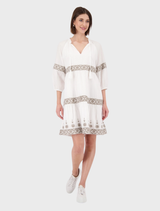 Cream round neck dress featuring intricate embroidery details throughout the fabric.