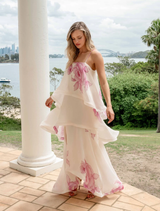 Elegant cream and pink floral gown with tiered layers, presented on a mannequin for visual reference.