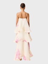 Cream and pink floral gown with tiered layers, elegantly showcased on a mannequin, illustrating its graceful style.