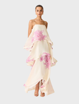 Mannequin featuring a cream and pink floral tiered gown, emphasizing its delicate fabric and intricate design.