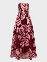 Elegant strapless gown adorned with a colorful floral print, perfect for formal occasions.