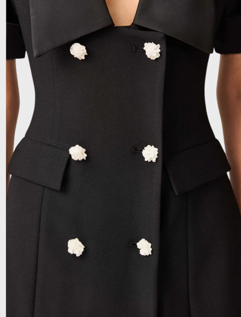 Black blazer dress crafted from a soft wool blend, showcasing a sleek and sophisticated design.