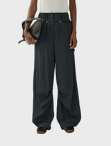 Black trousers with a rusty effect, presenting a blend of modern fashion and vintage flair.