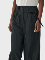 Black trousers characterized by a rusty, aged look, offering a unique fashion statement.