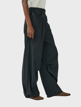Black trousers with a rusty effect, blending contemporary style with a retro vibe.