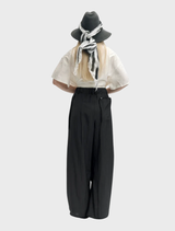 Close-up of black trousers with a rusty texture, illustrating their stylish wear and contemporary appeal.