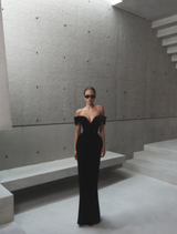 Elegant black Ryn gown displayed on a mannequin, showcasing its sleek design and flowing fabric.