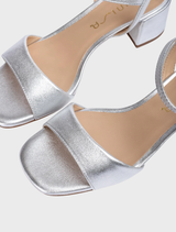 Elegant silver sandal with a wide heel, perfect for enhancing any outfit while ensuring comfort.