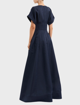 Close-up of a navy sapphire gown, highlighting its luxurious fabric and elegant neckline.