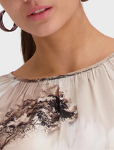 Savanna blouse in a sand pattern, showcasing a comfortable design suitable for warm weather outings.
