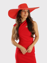 Elegant red boater hat with a large flat brim, suitable for Ladies Day and weddings, featuring a structured crown for a chic look.