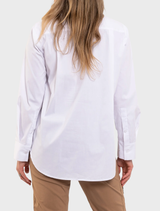 White Saville shirt with a tailored fit, featuring a collar and buttons, displayed on a hanger for viewing.