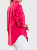 Saville Shirt in raspberry, showcasing a longline silhouette, crisp collar, and stretch fabric for versatile wardrobe styling.