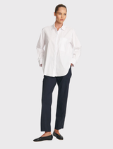 Saville Shirt in white, showcasing a polished finish, curved hem, and concealed placket, made from lightweight microprene fabric.