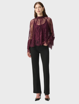 Scalloped lace trapeze top in elderberry with stand collar, keyhole back, and flounce cuffs for a refined silhouette.