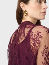 Elegant elderberry lace trapeze top with a stand collar, keyhole back, and flounce cuffs for a refined, flowing look.