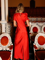 The Evangeline Gown in Scarlet offers a romantic bias-cut silhouette, asymmetric neckline, and a keyhole back detail.