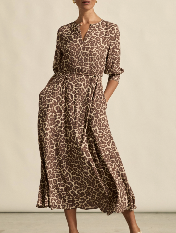  Leopard print midi dress made from soft, lightweight fabric, perfect for stylish and comfortable wear.
