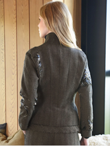 A gravel Seam A Little Seam Jacket, highlighting its minimalist design and structured shape, presented on a hanger.