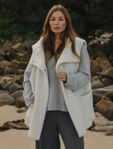 Sherpa cuddle gilet in latte color, featuring a soft, cozy texture and a stylish, sleeveless design for warmth and comfort.