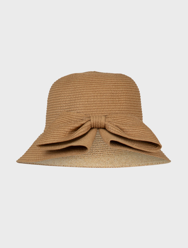 Tan straw bucket hat featuring a decorative bow on the front, labeled She's All Hat Hat.