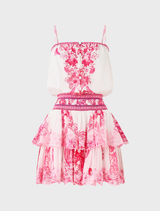 Playful fit-and-flare mini dress in pink and white, with a shirred waist and adjustable straps for a custom fit.