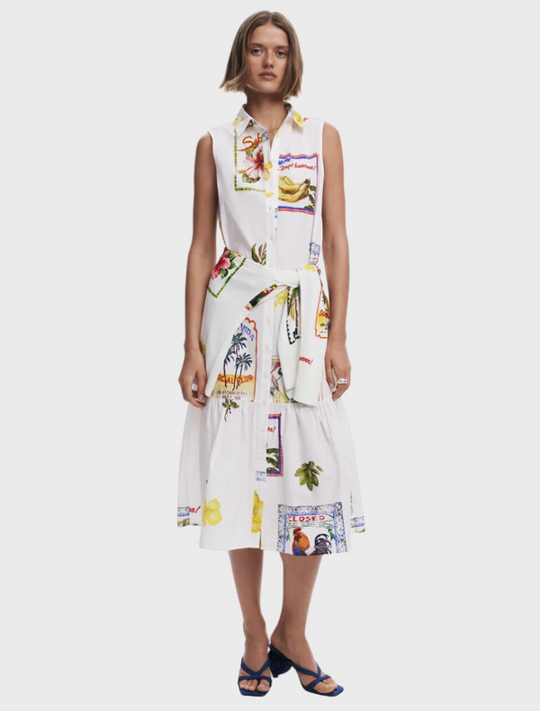 A white dress featuring a vibrant, colorful print throughout its fabric.