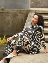 Casual shirt in black and stone colors, presented on a table, emphasizing its versatile and trendy appearance.