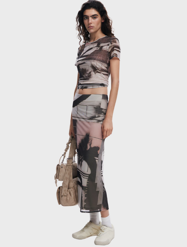 A woman dressed in a shirt with an eye-catching pattern, reflecting her personal style and fashion sense.