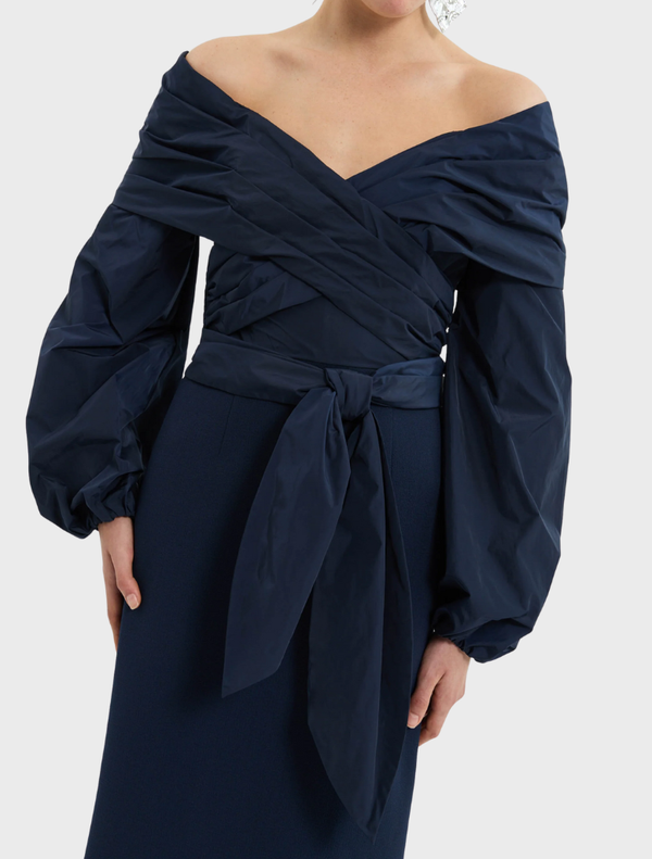 Stylish navy Sibylla Gown with a prominent bow detail on the shoulder.
